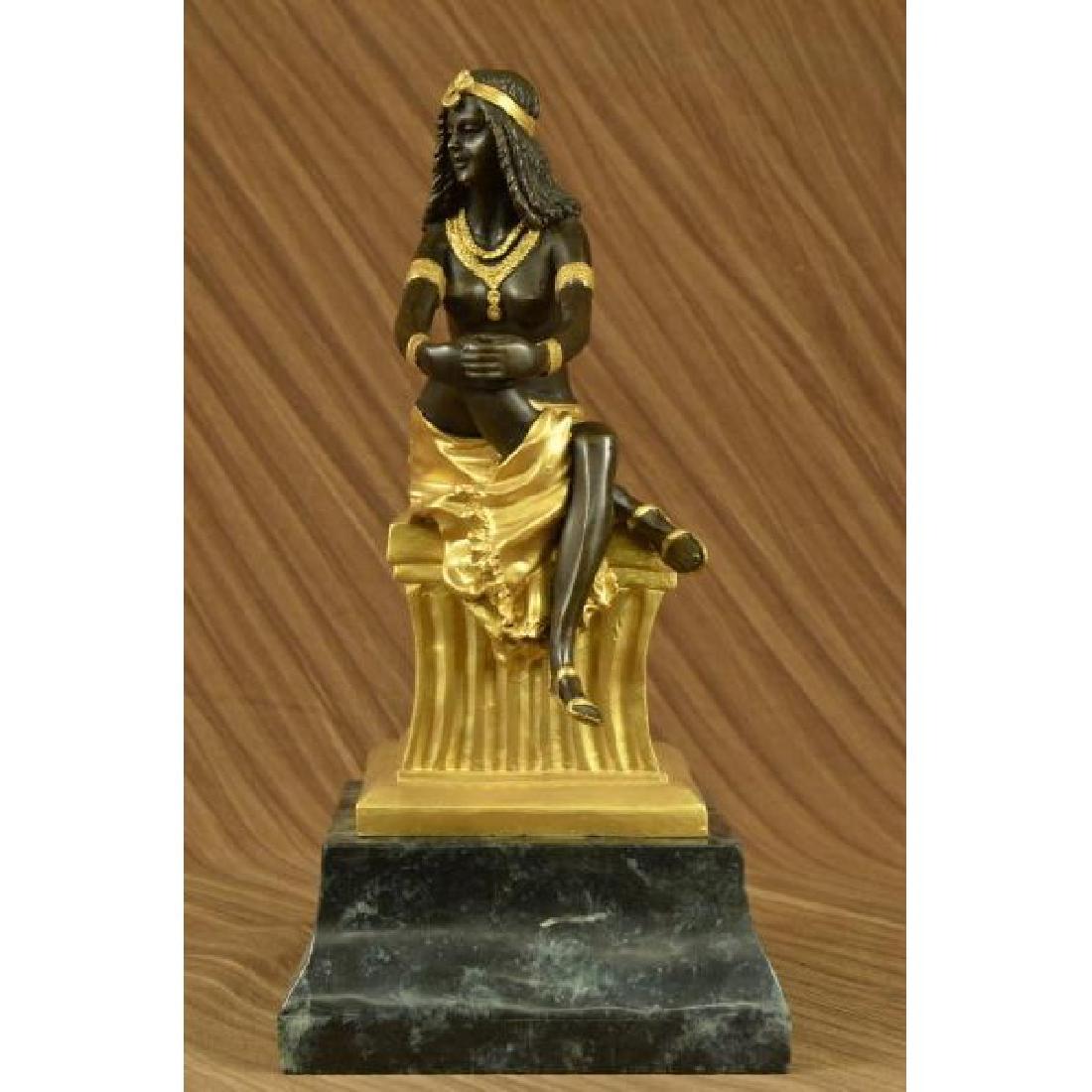 SIGNED BRONZE ART NOUVEAU DECO CHIPARUS STATUE FIGURINE: This beautiful sculpture of a woman sitting on a high gold thick pillar. She poses while she sits and holds her right knee that is place under her left leg. She is topless but wears a nice long s