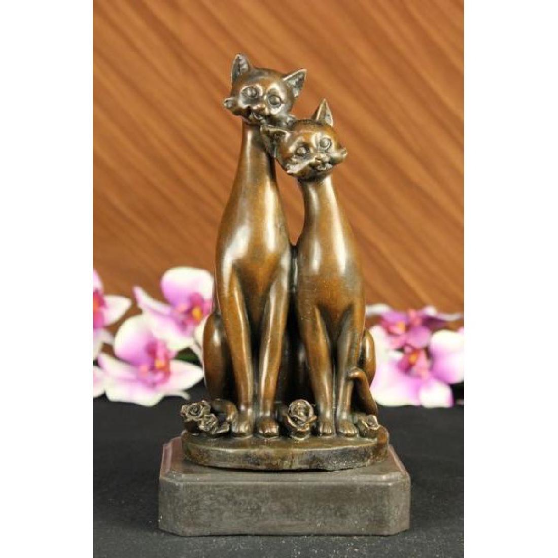 OLD CAT BRONZE SIGNED FIGURINE ON BASE CATS ART DECO: The pair of slender cats sit next to each other purring and staring out amiably and saucer-eyed. Rose buds litter the ground where their dainty paws meet and their curled tails twine. Some attributes 