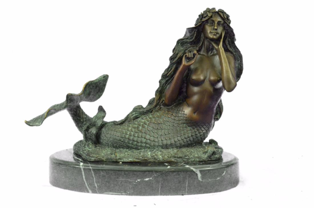 NUDE BRONZE MERMAID WITH GREEN PATINA: Many people find the mystery of mermaids enchanting, and if you've spent much time out to sea, you might have a mermaid story of your own to tell. (Don't embellish too much, you might be accused of te