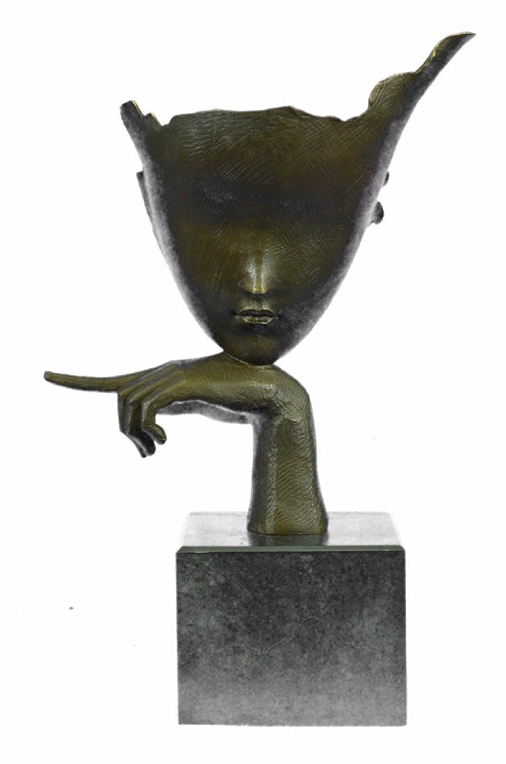 Female Bronze Sculpture on Marble Base Statue: Blind beauty is a simple designed Sculpture of a face that is designed like a mask and asking for tranquility by its pointed index finger. This modern Bronze Sculpture was affixed on a marble base. Li