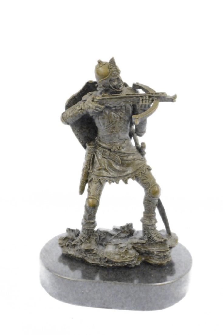 Japanese Warrior Bronze Sculpture: This ancient warrior creeps up the muddy hill, stalking his enemy. Though he wears boots, his moves are stealth. He holds up a crossbow and lines his target. His brow furrows intensely with killer foc