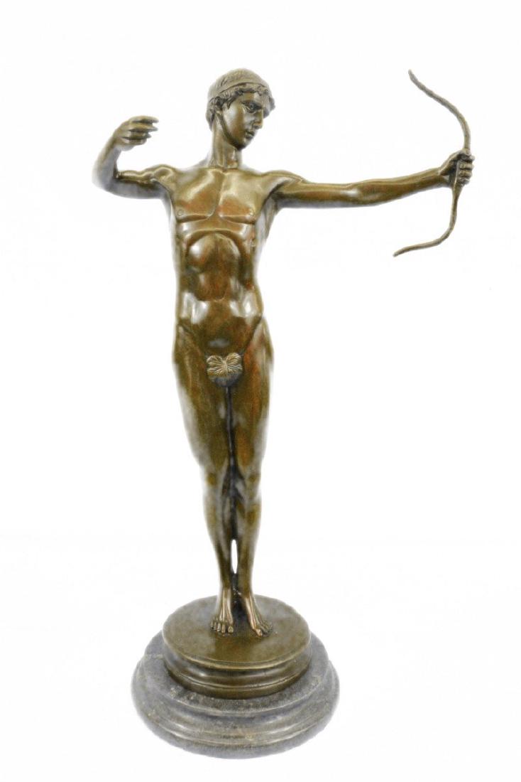 Nude Roman Archer Bronze Sculpture: Here a man pulls his bow tight and releases letting his arrow flythrough the windy air with might. A fig leaf covers his privates ashe executes perfection in his shot and perfect posture. His hair isc