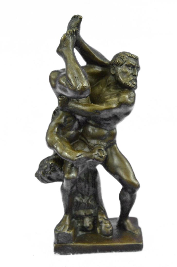 Nude Hercules Victorian Bronze Statue: This extremely unique piece features two nude bearded men in the midst of a very intense battle. Their stern faces show that they are very serious.One man has lifted the other man and has him upside d