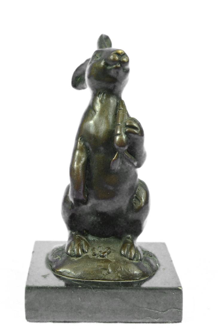 Animal Edition Bronze Bunny With Carrot Sculpture: This cute bunny looks up with the sweetest look and holds a carrot in his tiny arms. This little rabbit is the perfect touch of decor for a sweet and loving home. His ears are long and he stands on hi