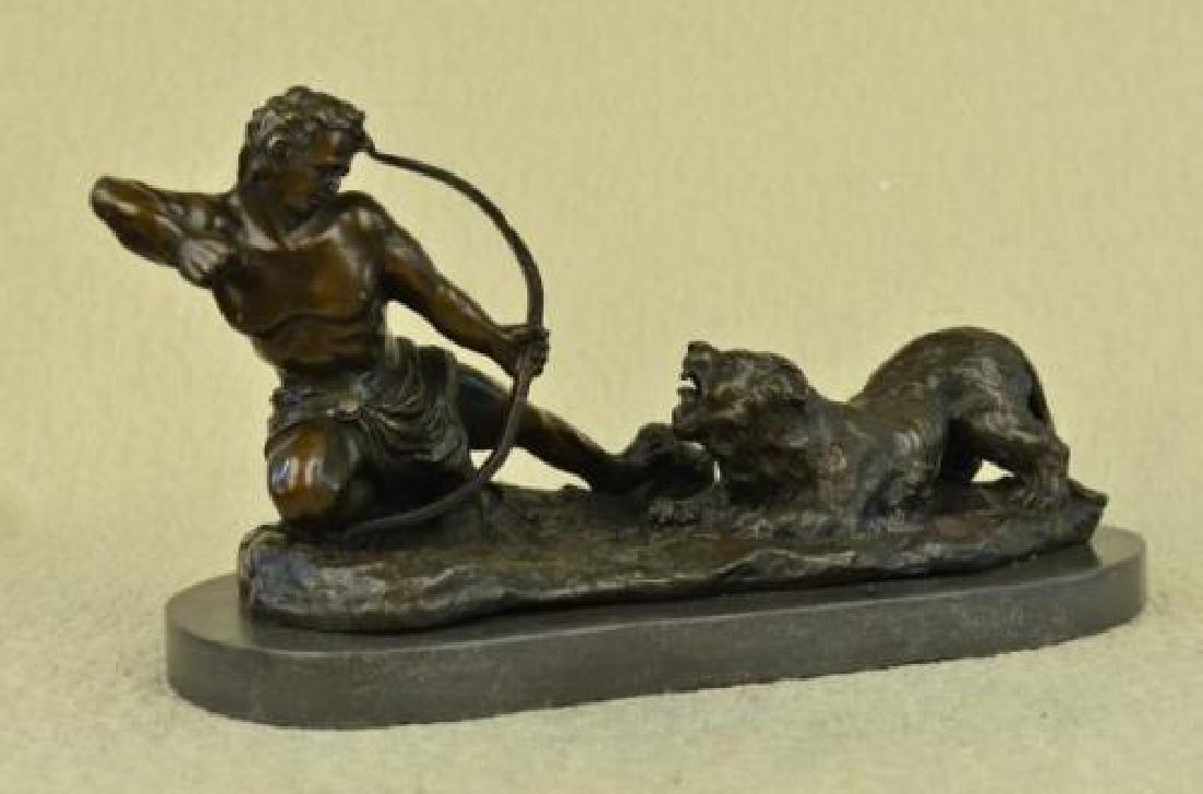 Man With Bow and Arrow Striking Lion Bronze Sculpture: This lovely Sculpture of a man about to strike this lion with a bow and arrow. The lion has his mouth wide open ready to attack the man but the man wont give up to win this battle. The handmade Bronze