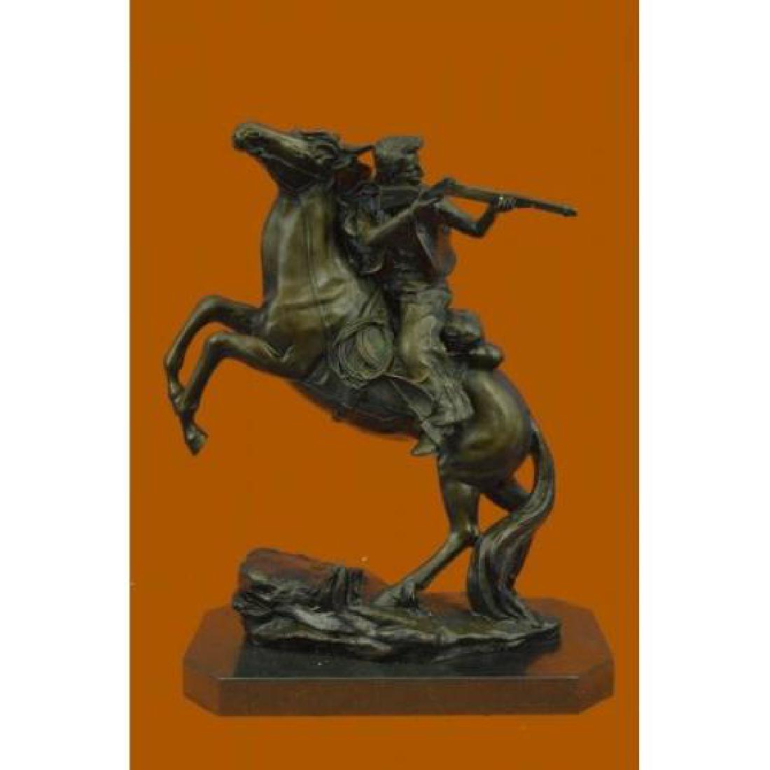 Outlaw Sheriff with Gun on Horse Bronze Statue: Its the Wild Wild West. This gunslinger, comfortable on his rearing horse, looks over the horses neck to watch ahead for his enemy. Hes ready to fire his weapon if need be as he travels hurriedly thro
