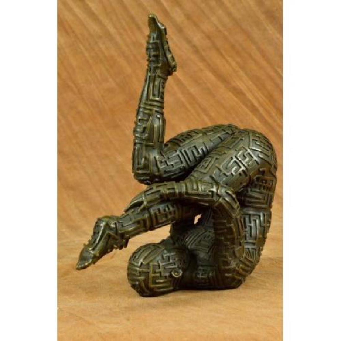 Yoga Exercise Bronze Sculpture: This abstract is a very odd and creative one, I guarantee you that you will have people talking about it. You can tell its a figure of a man suspended in air wearing an unusual design outfit , but the