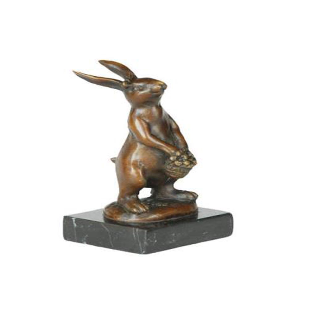 Lady Bunny With Flower Basket Bronze Sculpture: This cute and cuddly Lil lady looks up with the sweetest look and holds a tiny basket full of flowers in her tiny arms. This little bunny is the perfect touch of decor for a sweet and cute look. Her e