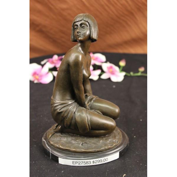 Shy Girl Bronze Sculpture: Young Girl in Thought A Classic Bronze Lost Wax Process Cire Perdue. This statue is mounted on a marble base. It depicts a young nude girl sitting in a pensive pose. Her crop cut hairstyle beautifully