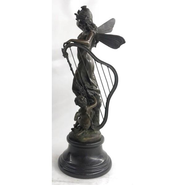 Butterfly Angel Nymph Fairy Bronze Sculpture: A young cherub reaches to a fairy to gain her attention. The beautiful fairy reaches back to the cherub with a delicate to his playful curls. She is holding a musical Harps in this enchanting sculptur