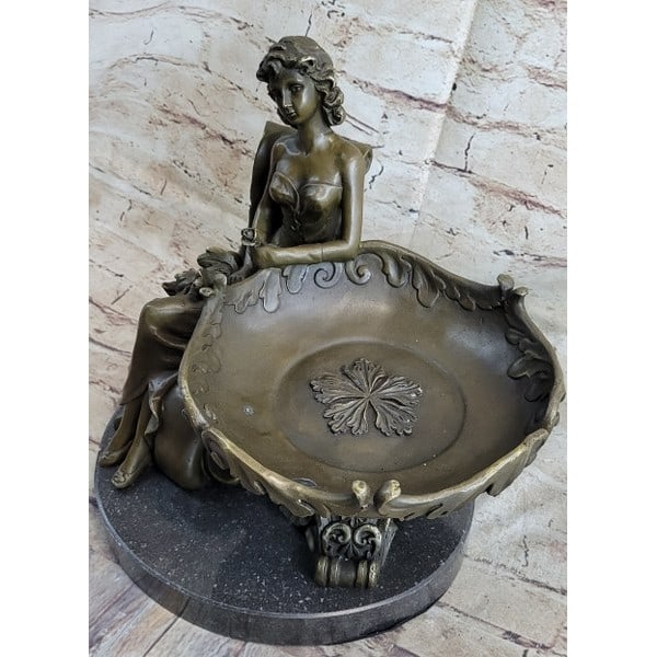 Business Card Holder Bronze Sculpture: This decorative sculpture is one that will surely fascinate and delight. A young girl rests with a large stylish plate placed on her lap. She is half-nude with her skirt flowing back behind her. The p