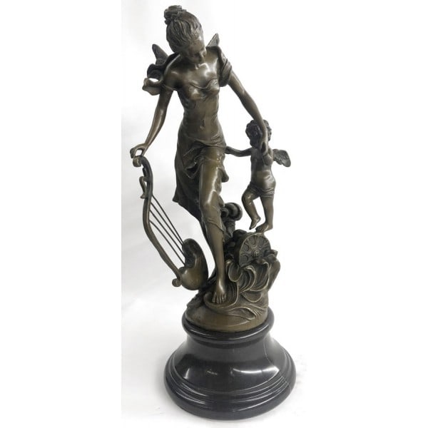 Fantasy Winged Fairy with Mythical Bronze Sculpture: A young cherub reaches to a fairy to gain her attention. The beautiful fairy reaches back to the cherub with a delicate to his playful curls. She\'92s holding a musical Harps in this enchanting sculpt