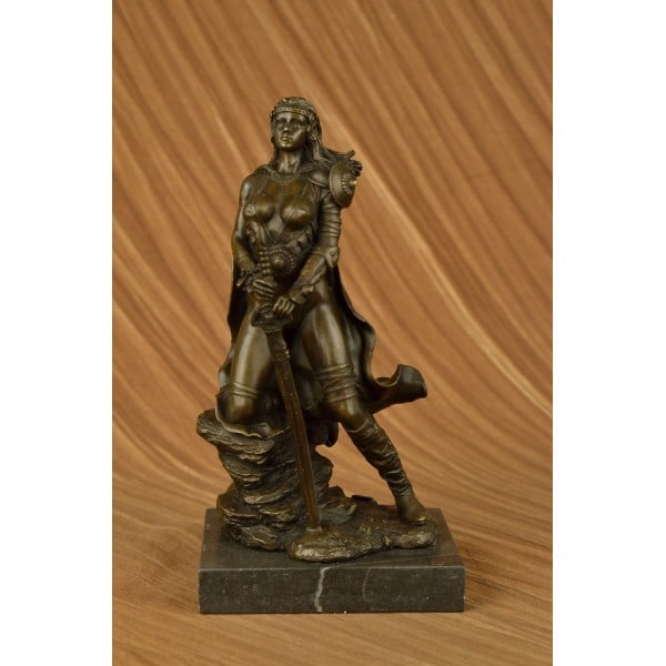 Amazon Warrior Bronze Sculpture: A sexy and tough Amazon warrior stands proudly holding her sword. Her other arm is tense, highlighting her sculpted arms. Her large breasts are dressed in a studded bikini. She is a fighter in the wil