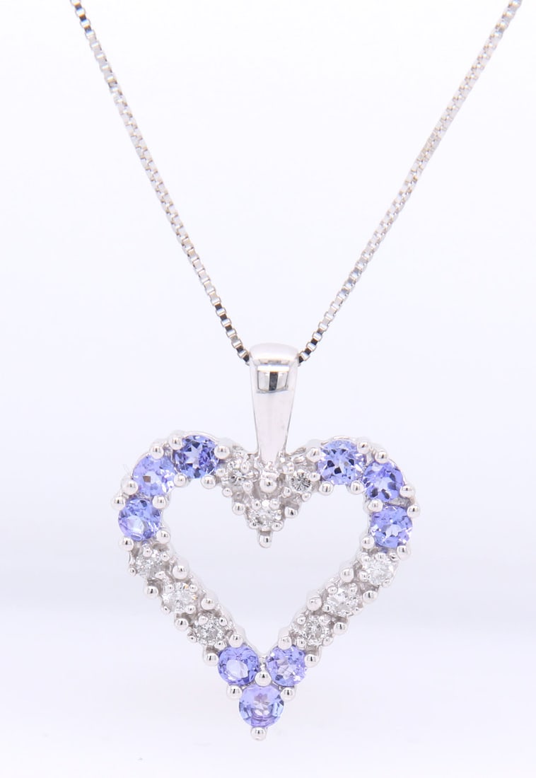 Divine White Gold Diamond and Tanzanite open Heart Shaped Pendant on Box Chain Necklace: Divine 14kt White Gold approximate 0.18ctw Diamond and Tanzanite open Heart Shaped Pendant on 18 inches Box Chain Necklace. Total weight of Necklace 3.30 Grams.