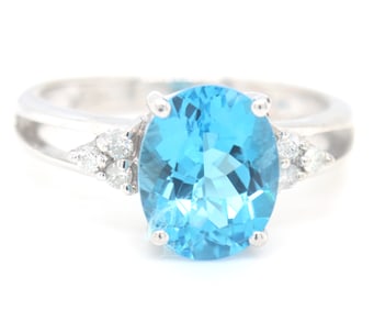 14kt White gold oval blue topaz and diamond open shank ring