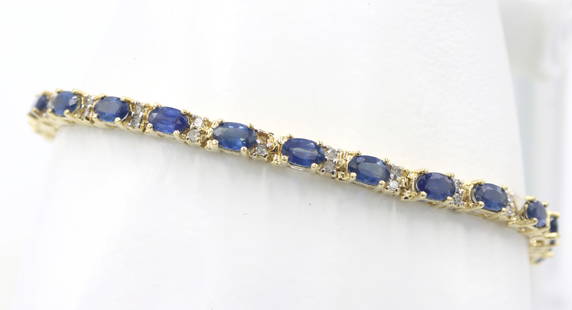 14kt Yellow gold blue sapphire and diamond tennis bracelet: 14kt Yellow gold approximate 8.40ctw oval blue sapphire and diamond accent 7.25-inch tennis bracelet. The total weight of the bracelet is 10 grams.