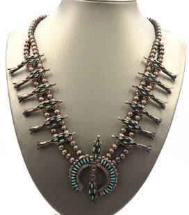 Edaaki Vintage Native American Zuni turquoise necklace: Edaaki Vintage Native American Zuni turquoise 925 sterling silver squash blossom 24-inch necklace. The total weight of the necklace is 75.9 grams.