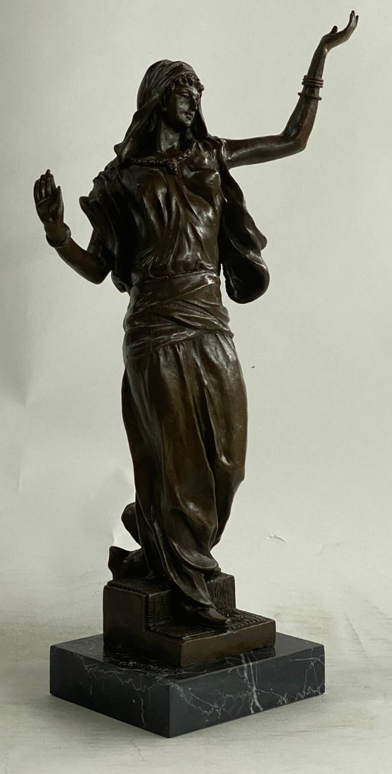 Arab Girl Dancing Bronze Sculpture: This lovely sculpture of an Arabian woman Standing gracefully and dancing. She is really concentrated on the musical instrument playing on the radio, she carefully listening to music not to make any m