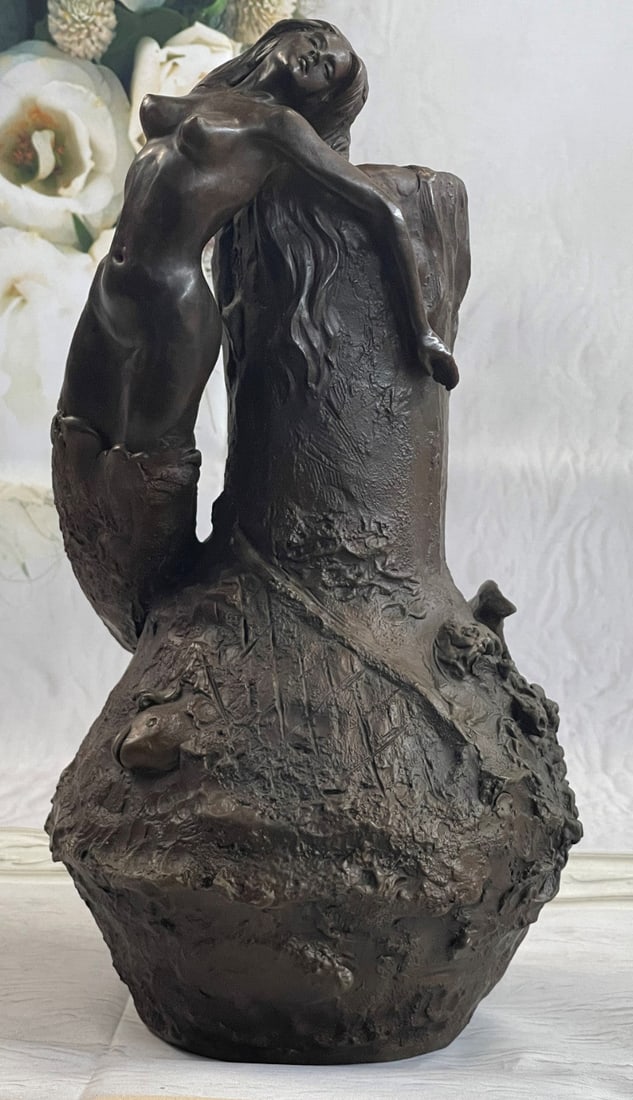 Special Patina Nude Mermaid Vase Planter Bronze Sculpture: This is an oval base shape and a very decorative art nouveau handle in the form of a mermaid. The vase has a decorative design and the spout has a fish design. The handles depict a mermaid sitting und