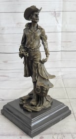 Old Cowboy Holding his Saddle Bronze Sculpture