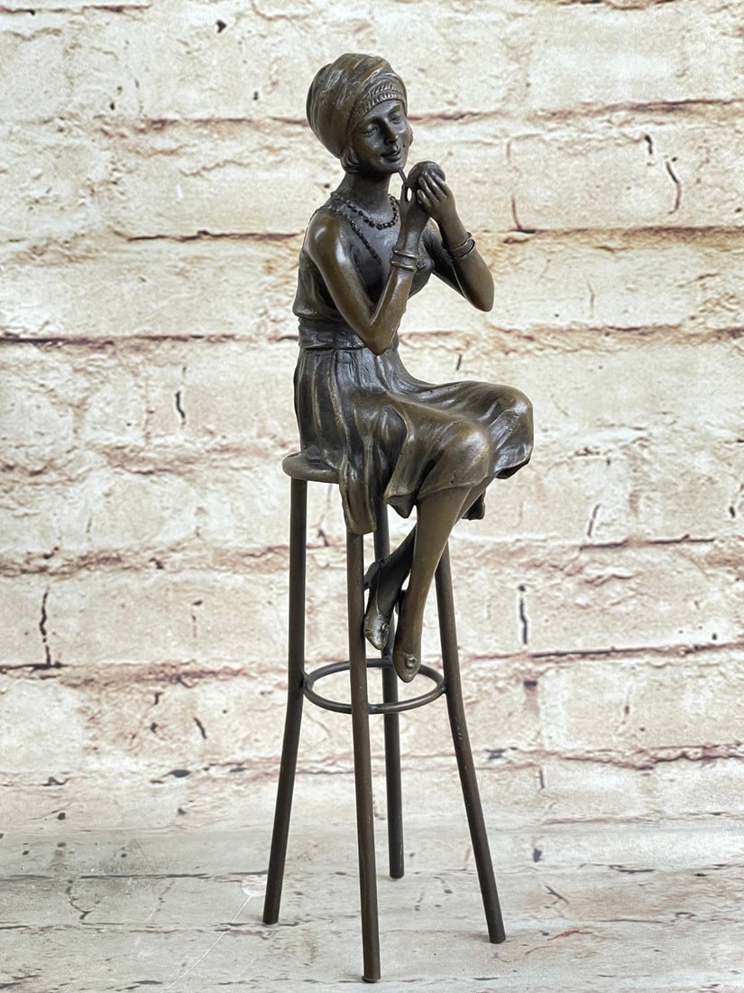 1920 High Fashion Art Deco Nouveau Girl Bronze Sculpture: This statuette by world-renowned artist, Demetre Chiparus features a lady sitting atop a high chair with her legs folded. She meticulously holds a compact mirror in her hand as she applies her lipstic