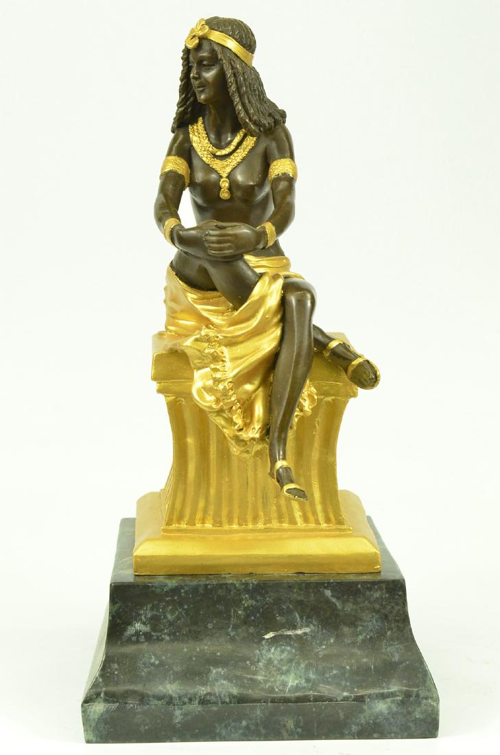 Art Nouveau Bronze Statue on marble base Figurine: This Beautiful Sculpture Of A Woman Sitting On A High Gold Thick Pillar. She Poses While She Sits And Holds Her Right Knee That Is Place Under Her Left Leg. She Is Topless But Wears A Nice Long Skirt 