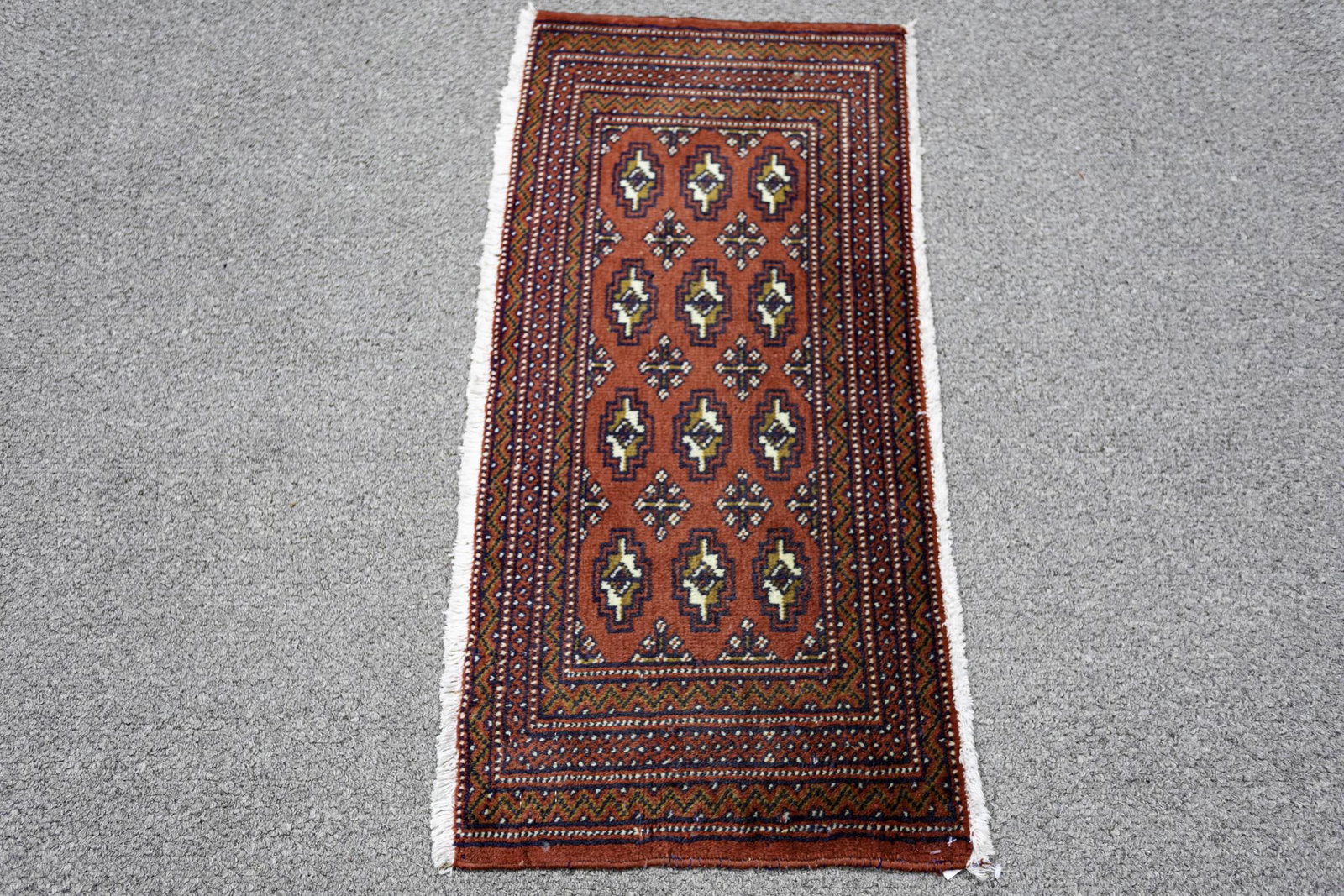 Handmade Persian Turkman 1.8x3.5: Handmade Persian Turkman Rug. Size 1.8x3.5 ft., made of high quality wool pile on cotton foundation, incorporating all over geometric and floral patterns on a rich red background, and finished off bea