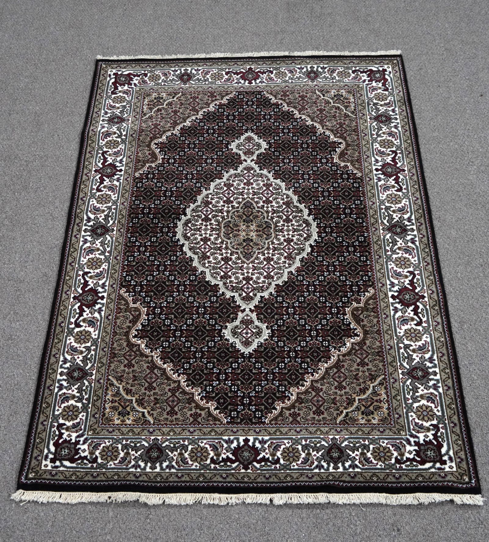 Handmade Tabriz Fish Design 4.2x6.1: Handmade Tabriz Fish Design Rug. Size 4.2x6.1 ft., made of quality wool with silk highlights pile on cotton foundation, finished off beautifully with a floral borders. Hand woven in India.