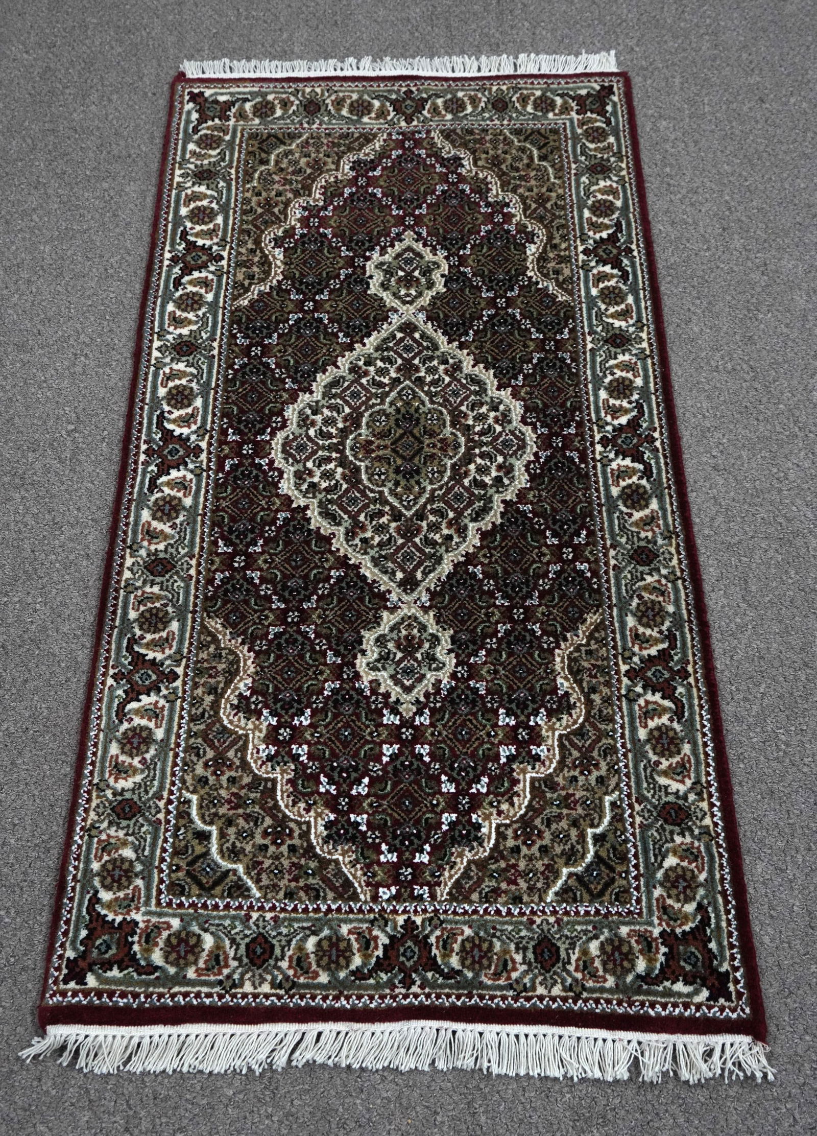 Handmade Tabriz Fish Design 2.5x4.10: Handmade Tabriz Fish Design Rug. Size 2.5x4.10 ft., made of quality wool with silk highlights pile on cotton foundation, finished off beautifully with a floral borders. Hand woven in India.
