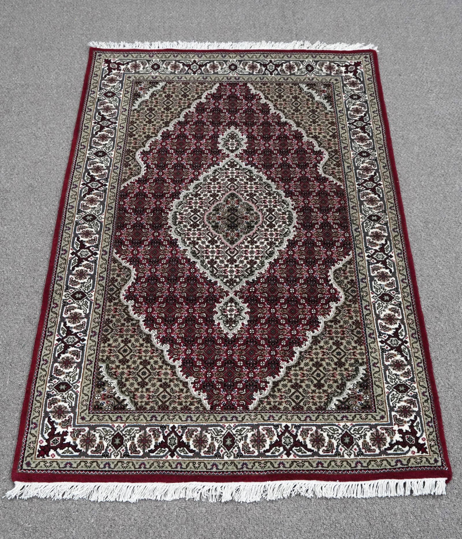 Handmade Tabriz Fish Design 4.0x6.0: Handmade Tabriz Fish Design Rug. Size 4.0x6.0 ft., made of quality wool with silk highlights pile on cotton foundation, finished off beautifully with a floral borders. Hand woven in India.