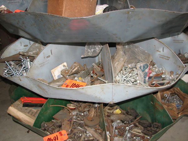 FOURTH SHELF DOWN OF ROTATING BIN INCLUDING MISC.: FOURTH SHELF DOWN OF ROTATING BIN INCLUDING MISC. CASTERS, NUTS AND BOLTS, ANTIQUE DOOR HINGES, LOCKS, AIR HOSE, CASTERS