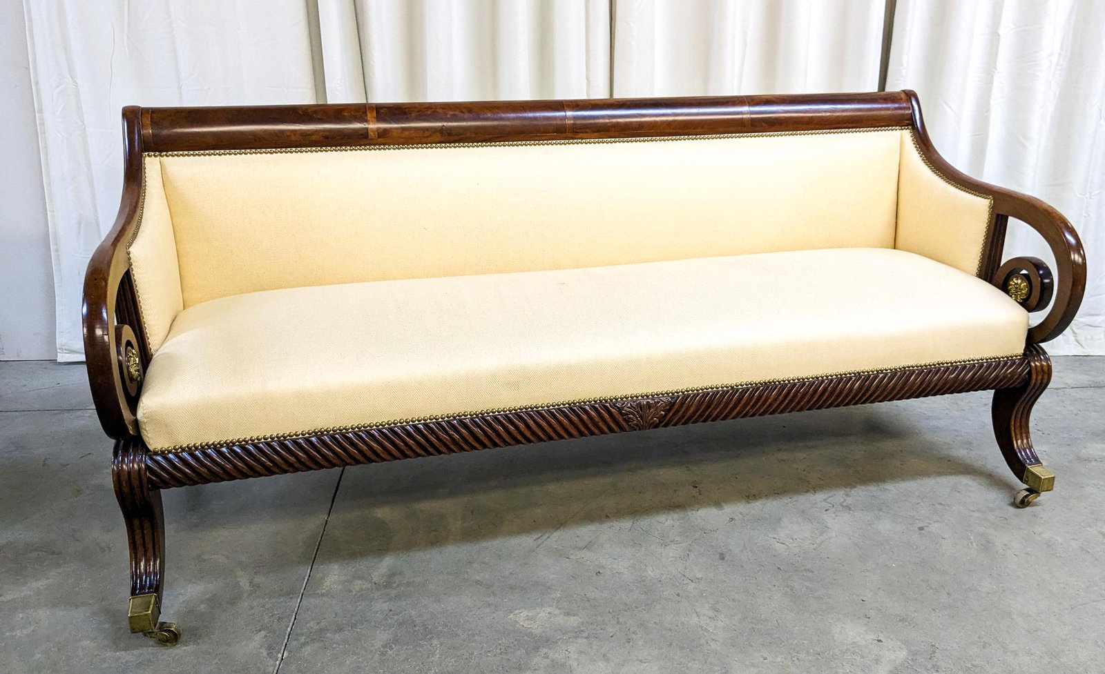 Sheraton Upholstered Scroll Arm Sofa: Sheraton Upholstered Scroll Arm Sofa, with brass details, carved accents Size 32" (back height) x 76" x 29" Literature Brooks Auction is not responsible for outbids. Questions? Call the office at (8