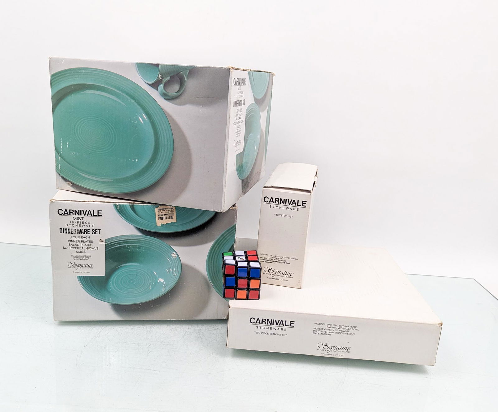 Carnivale Dinnerware Set in "Mist" Color: Carnivale Dinnerware Set in "Mist" Color: two 16 piece dinnerware sets - spoon rest and salt and pepper shakers in box - two piece serving set in box Literature Brooks Auction is not responsible for