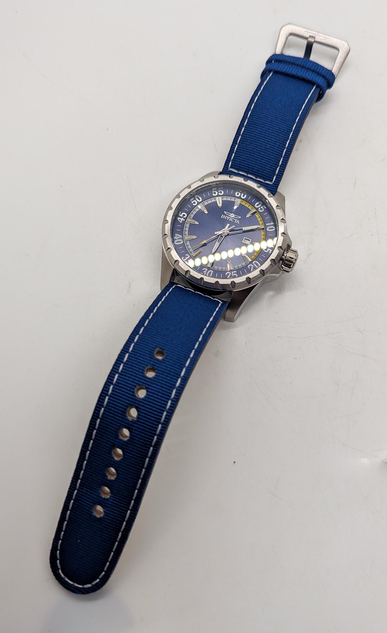 Invicta Aviator Men's Watch: Invicta Aviator Men's Watch, model 19414, with Japan movement and nylon band, blue Literature Brooks Auction is not responsible for outbids. Questions? Call the office at (856) 694-2960 or email us d