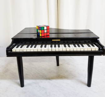 Children's Toy Grand Piano: Children's Toy Grand Piano, some wear with age, loose bottom leg Literature  Brooks Auction is not responsible for outbids. Questions? Call the office at (856) 694-2960 or email us directly at info@br