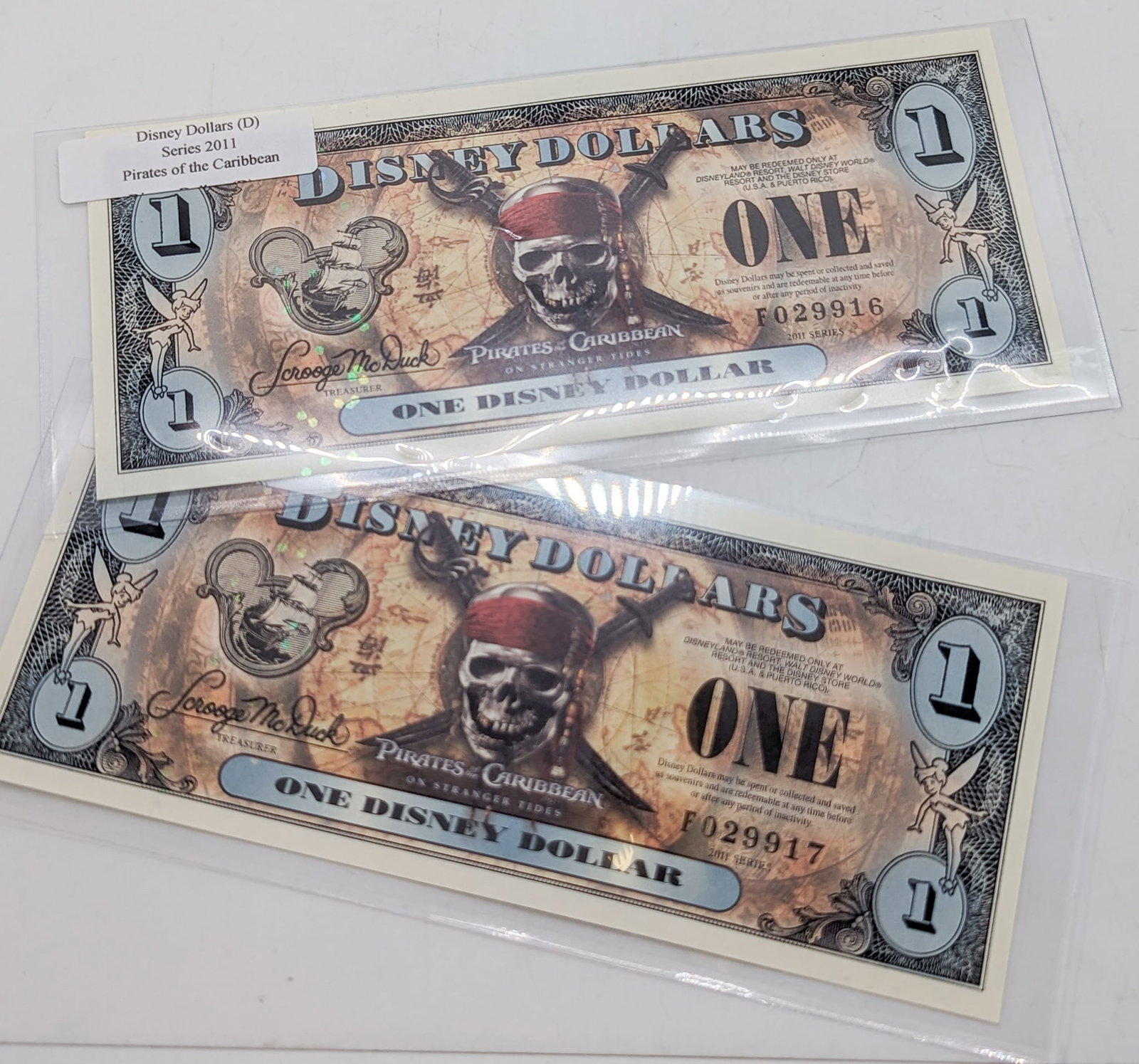 Two Disney Dollars 2011 F Pirates of the Caribbean: Two Disney Dollars 2011 F (consecutive) Pirates of the Caribbean Literature Brooks Auction is not responsible for outbids. Questions? Call the office at (856) 694-2960 or email us directly at info@bro