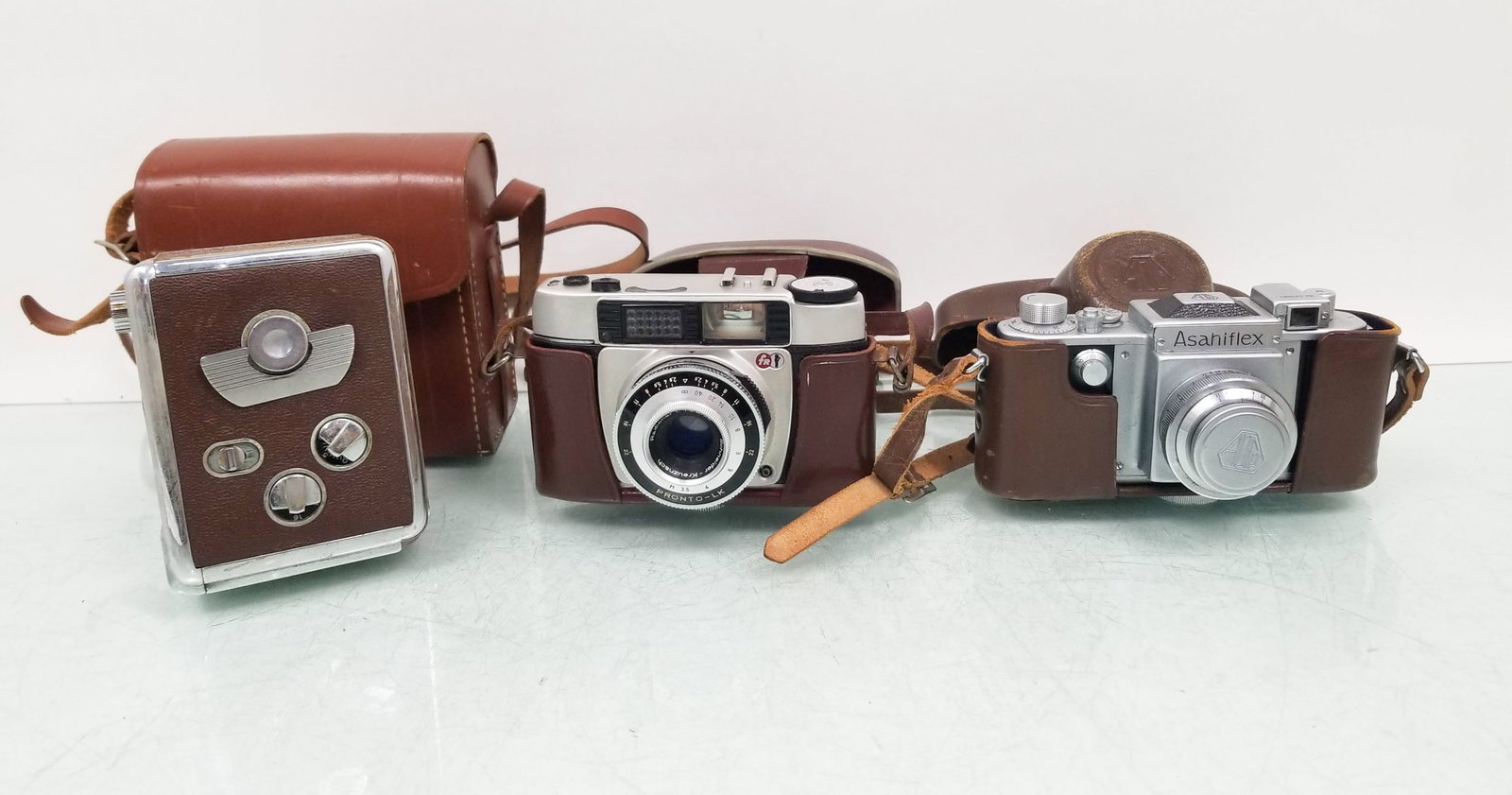 Vintage Cameras: Vintage Cameras: Asahiflex no. 72990 - FR Pronto LK - Revere 8 - and more Size 7" x 12" x 12" Literature Brooks Auction is not responsible for outbids. Questions? Call the office at (856) 694-2960 o
