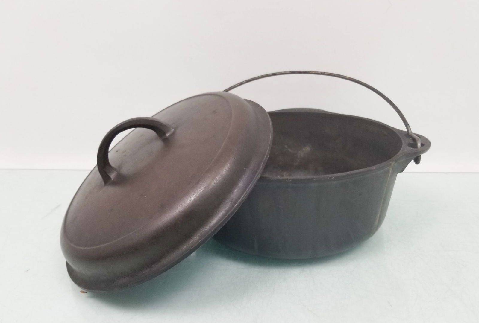 Griswold 8 Cast Iron Dutch Oven: Griswold 8 Cast Iron Dutch Oven Size 7" x 12" Literature Brooks Auction is not responsible for outbids. Questions? Call the office at (856) 694-2960 or email us directly at info@brooks.auction. <