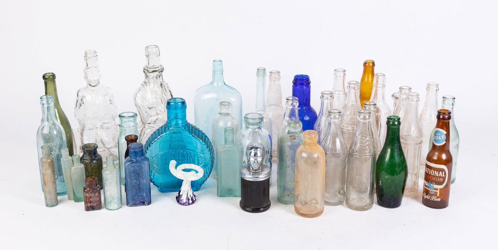 Vintage and Antique Glassware: Vintage and Antique Glassware: antique bottles - vintage soda bottles - Poland Water Moses bottle - and more Size 7" x 24" x 24" Literature Brooks Auction is not responsible for outbids. Questions?