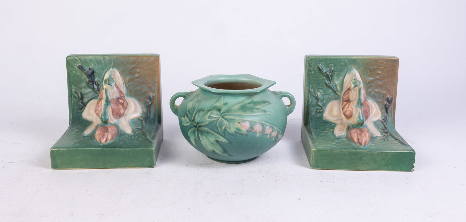 Three Pieces of Vintage Roseville Pottery: Three Pieces of Vintage Roseville Pottery: Roseville 377-4 lily of the valley vase - pair of Roseville 13 bookends Size 6" x 5" x 6" Literature Brooks Auction is not responsible for outbids. Questio