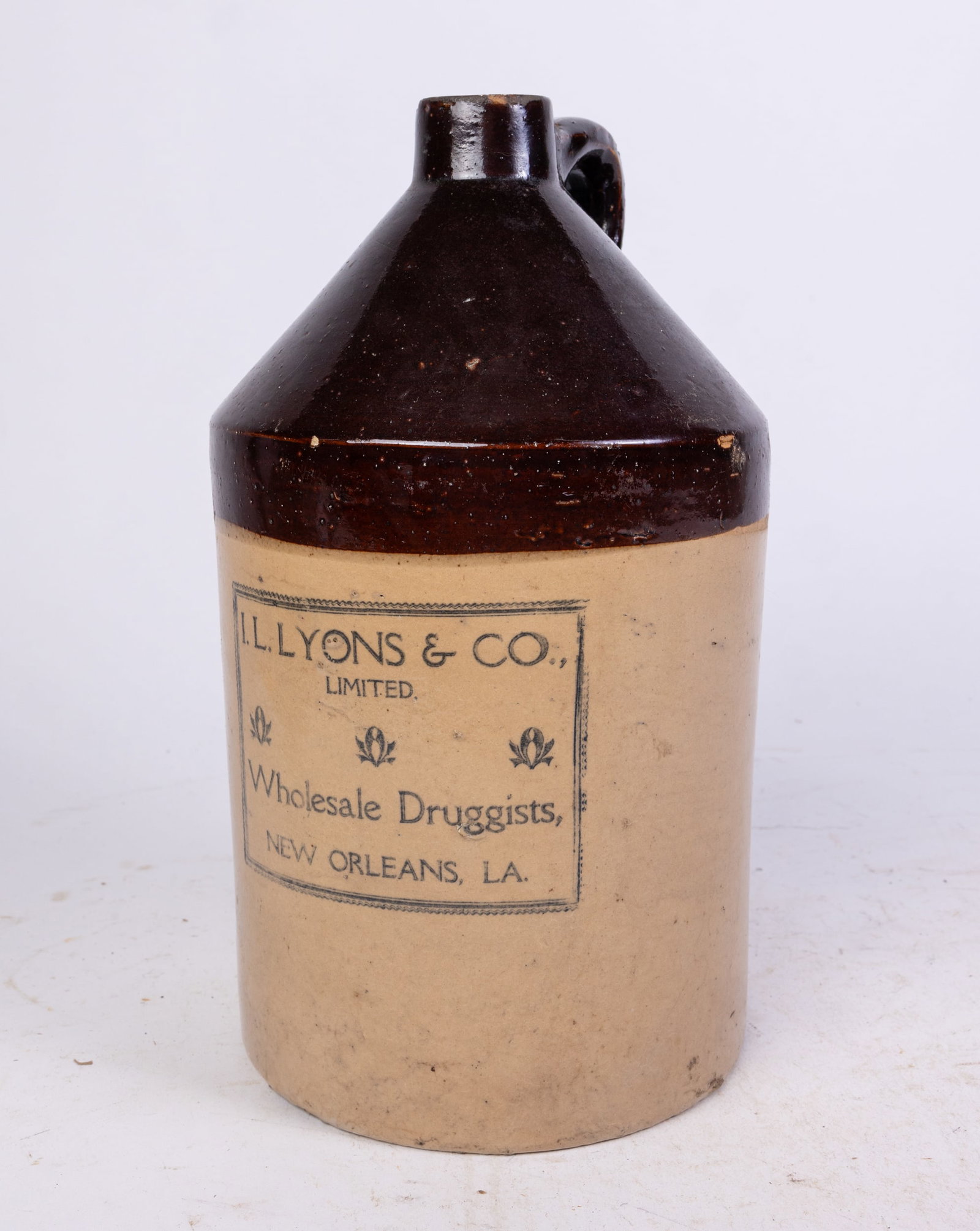 I.L. Lyons & Co. Limited Wholesale Druggists 1-Gallon Stoneware Advertising Jug: I.L. Lyons & Co. Limited Wholesale Druggists 1-Gallon Stoneware Advertising Jug Size 12" x 6.5"d Literature Brooks Auction is not responsible for outbids. Questions? Call the office at (856) 694-296