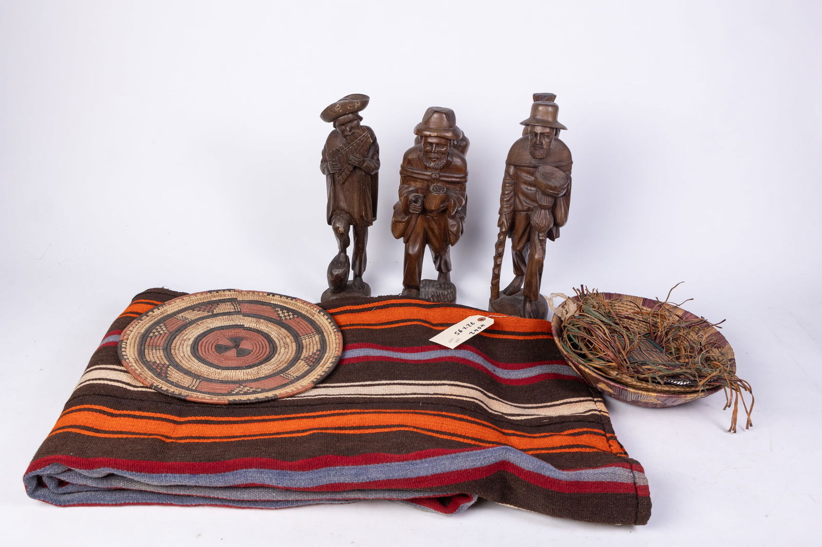 Assortment Lot: Assortment Lot: woven Southwest style rug - woven decorative baskets - carved wooden figures - and more Size 16'' x 24" x 20'' Literature Brooks Auction is not responsible for outbids. Questions? Ca