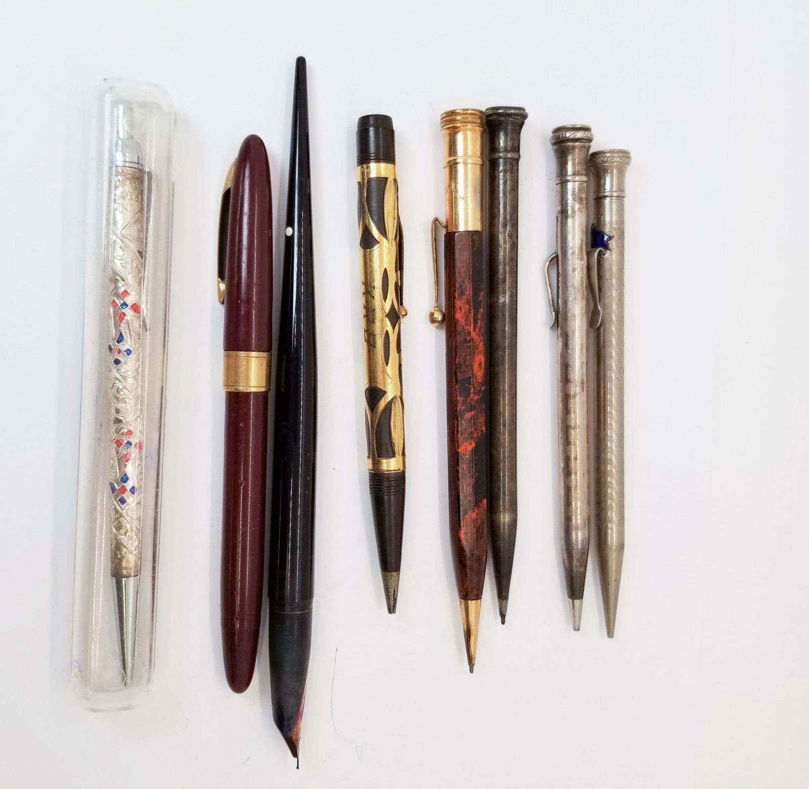 Six Pens and Two Pencils: (6) Pens and (2) Pencils: Sterling marked pen and matching mechanical pencil - Globus Pen in case marked Sterling 925 - pen with blue flag marked white gold plate - fountain pen with twist off lid, ti
