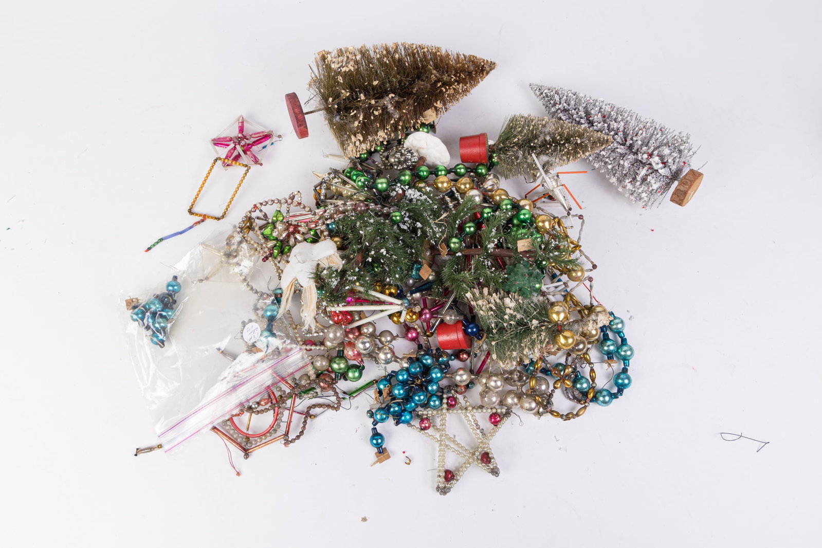 Lot of Vintage & Antique Christmas Decorations: Lot of Vintage & Antique Christmas Decorations: vintage garland - vintage trees - vintage ornaments Size 7" x 12" x 12" Literature Brooks Auction is not responsible for outbids. Questions? Call the
