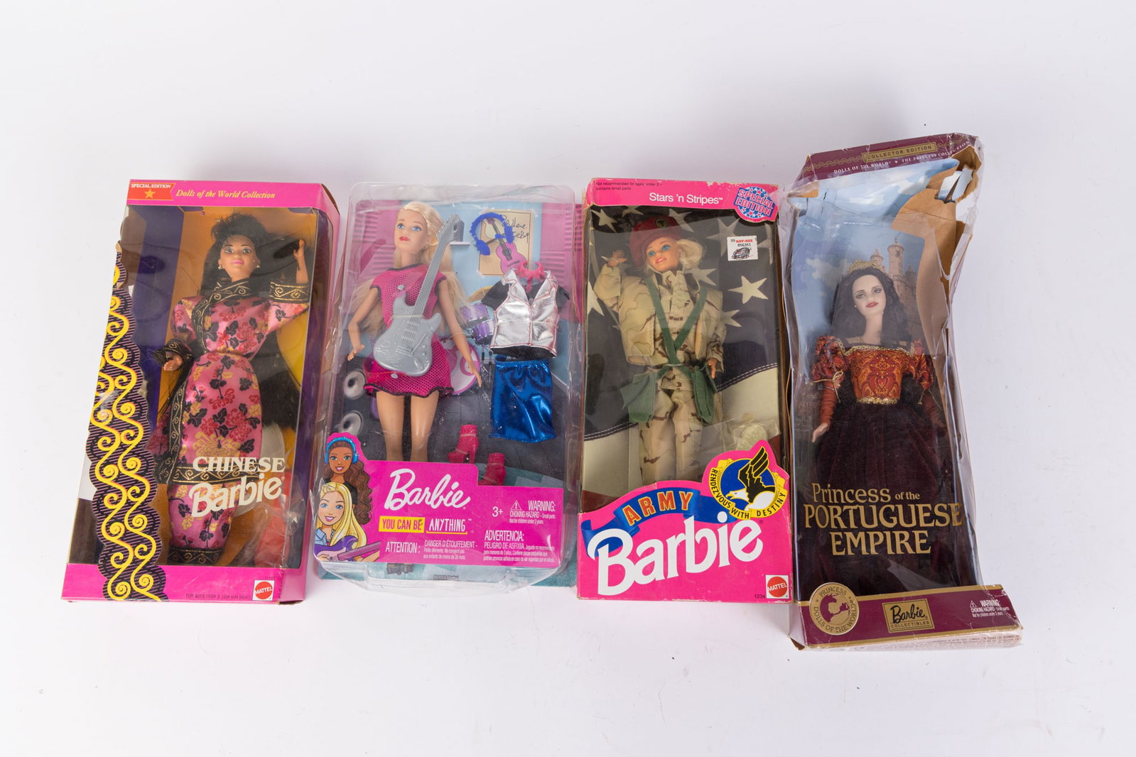 Barbie Four Piece Lot: Barbie Four Piece Lot: Princess of the Portuguese Empire - Chinese Barbie - Army Barbie - You Can Be Anything Barbie Size 7" x 12" x 12" Literature Brooks Auction is not responsible for outbids. Que