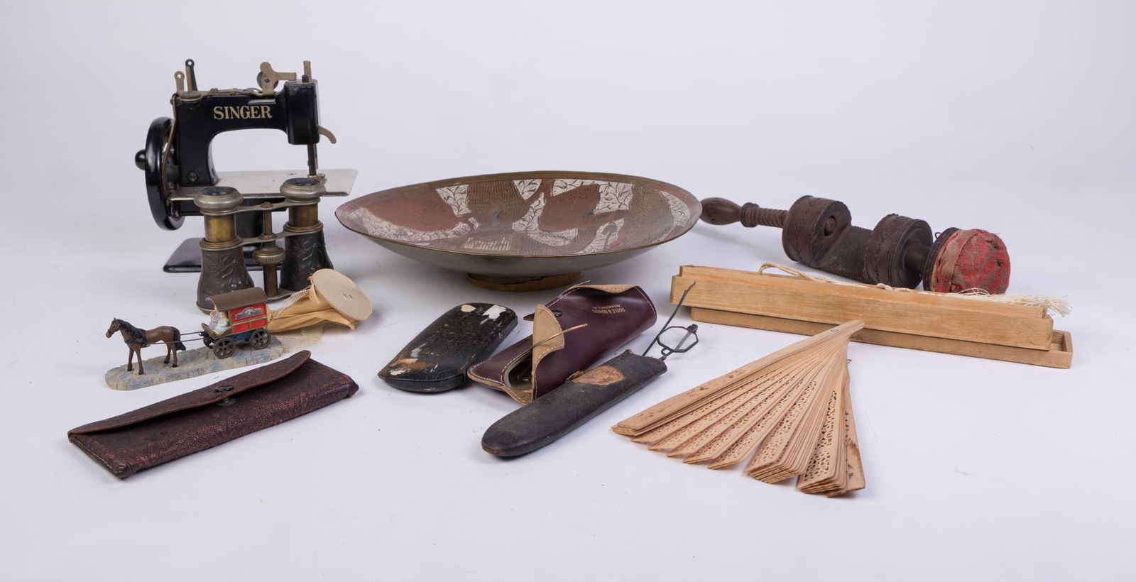 Lot of Assorted Antiques: Lot of Assorted Antiques: vintage children's singer sewing machine - antique eyeglasses - opera glasses - and more Size 7" x 12" x 12" Literature Brooks Auction is not responsible for outbids. Quest