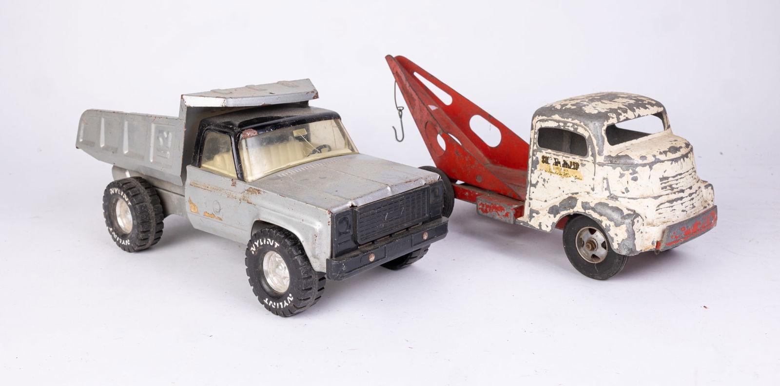 Two Vintage Metal Toy Vehicles: Two Vintage Metal Toy Vehicles: Smith Miller California Lead Toy Tow Truck - Nylint Metal Toy Dump Truck Size 6" x 14" x 7" (tow truck) Literature Brooks Auction is not responsible for outbids. Ques