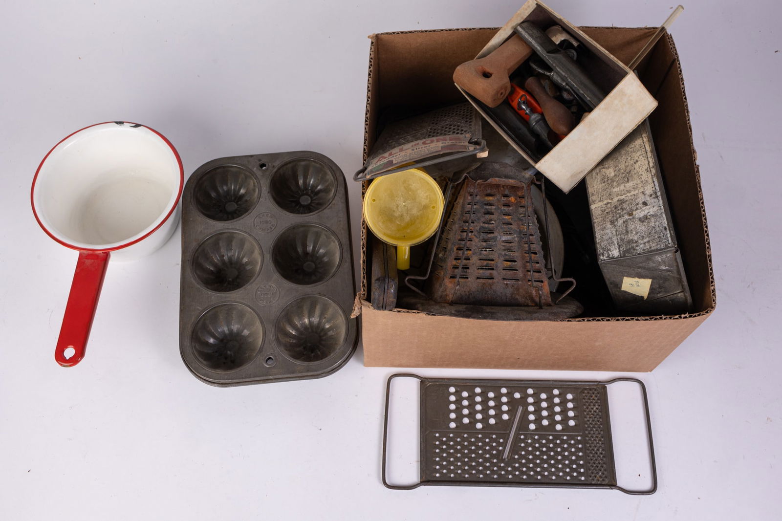 Vintage Kitchenware: Vintage Kitchenware: aluminum muffin pan - aluminum loaf pan - cheese graters - and more Size 7" x 12" x 12" (box size) Literature Brooks Auction is not responsible for outbids. Questions? Call the