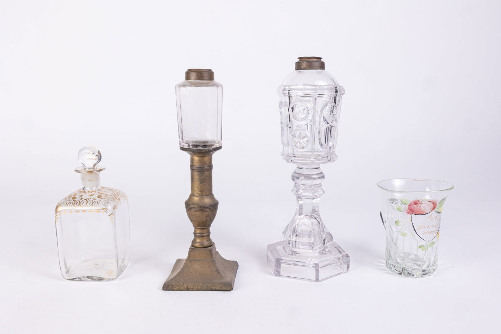Lot of Antique 19th Century Glassware: Lot of Antique 19th Century Glassware: antique oil lamp with star shaped molded design - antique blown glass cup with attached handle and hand painted design - antique blown glass decanter with gold p