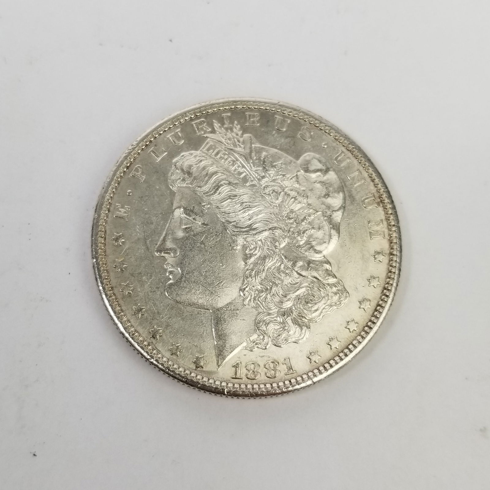 1881S Morgan Silver Dollar: 1881S Morgan Silver Dollar, .900 Silver Literature Brooks Auction is not responsible for outbids. Questions? Call the office at (856) 694-2960 or email us directly at info@brooks.auction. • Ple